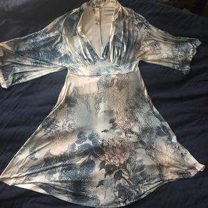 A figure hugging yet still dazzling swish of a fun blue & white flowered dress!